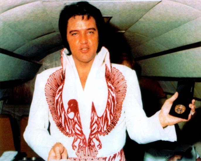 750603 Tuscaloosa (2) receiving a police badge on his plane in Tuscaloosa.jpg